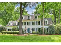 Beautiful traditional-style home featuring dormer windows, black shutters, and a well-manicured front lawn at 12028 Royal Lytham Ct, Charlotte, NC 28277