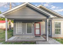 Charming single-story home features a gray exterior, a red door, and a covered front porch at 1263 Crawford Rd, Rock Hill, SC 29730