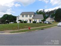 Charming two-story home with a well-maintained lawn and mature trees at 12803 Matisse Ln, Charlotte, NC 28215