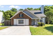 Charming single Gathering home with brick and gray siding, a concrete driveway, and well-maintained landscaping at 13914 Loch Loyal Dr, Charlotte, NC 28273