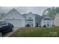 Charming one-story home featuring white siding, a two-car garage, and a stone-accented entryway at 1579 Matthews Dr, Rock Hill, SC 29732