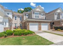 Charming townhome featuring a well-manicured front yard and a convenient two-car attached garage at 44449 Oriole Dr # 101, Indian Land, SC 29707