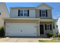 Two-story home with a neutral color scheme and a large two-car garage at 6114 Paw Village Rd, Charlotte, NC 28214