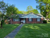 Charming single-story brick home with well-manicured lawn and inviting walkway at 712 2Nd Nw Ave, Conover, NC 28613
