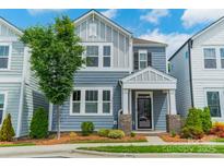 Charming two-story home with blue siding, white trim, and a well-manicured front yard at 804 Lyndon Station Dr, Pineville, NC 28134