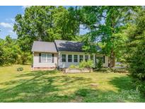 Charming home with lush green lawn and mature trees providing ample shade and curb appeal at 814 Independence Dr, Wingate, NC 28174