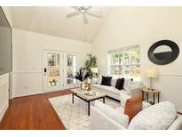 Bright living room with ceiling fan, hardwood floors, and French doors to the back yard at 8233 Christmas Ct, Charlotte, NC 28216