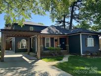 Charming two-story home featuring a cozy front porch and covered parking at 1019 Valley St, Kannapolis, NC 28081