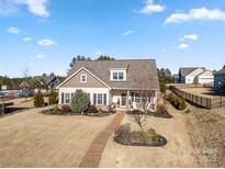 Charming single-story home featuring a welcoming front porch and well-manicured lawn, perfect for Gathering living at 11249 Island View Ln, Lancaster, SC 29720