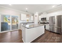 Eat-in kitchen showcasing a stainless steel fridge, granite countertops and a large center island at 11249 Island View Ln, Lancaster, SC 29720