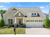 Charming home with a manicured lawn, complemented by a two-car garage and inviting front porch at 199 Blossom Ridge Dr, Mooresville, NC 28117