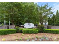 Park South Station community sign with mature trees, manicured shrubs, and colorful flowers, presenting an inviting entrance at 2151 Belle Vernon Ave, Charlotte, NC 28210