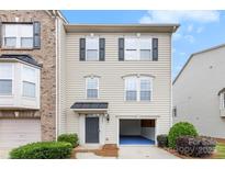 Charming townhome with neutral siding, black shutters, and an attached one-car garage at 2151 Belle Vernon Ave, Charlotte, NC 28210