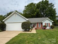 Charming single-story home featuring a well-manicured lawn, attached garage, and inviting front entrance at 2504 Faircroft Way, Monroe, NC 28110