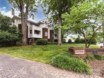 Beautiful condo building with manicured lawns and mature trees offers a serene and inviting entrance at 2719 Selwyn Ave # 20, Charlotte, NC 28209