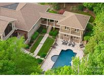 Stunning aerial view of an estate with a pool, outdoor lounge, meticulously landscaped grounds, and elegant architecture at 2915 Cutter Ct, Waxhaw, NC 28173