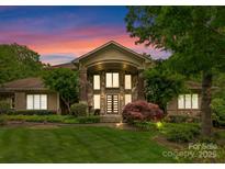 Stunning stone and shake home featuring manicured landscaping and a double door entry at 2915 Cutter Ct, Waxhaw, NC 28173