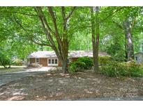 Charming brick home nestled among mature trees with a spacious front yard at 316 Anne Ave, Waxhaw, NC 28173