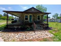 Charming stone cottage with a covered porch and decorative stone walkway at 4194 Buffalo Shoals Rd, Maiden, NC 28650