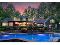 Stunning backyard with a large pool, elegant landscaping, and a covered patio perfect for entertaining at 8400 Prince Valiant Dr, Waxhaw, NC 28173