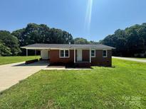 Charming single-story brick home with a well-manicured lawn and a convenient carport at 907 Mcgowan Rd, Shelby, NC 28150