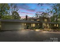 Charming single-Gathering home features an attached two-car garage, a paved driveway, and meticulously manicured landscaping at 115 Forestcliff Ne Ct, Concord, NC 28025