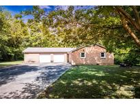 Quaint brick home featuring an attached two-car garage and a spacious driveway shaded by mature trees at 1491 Cedar Grove Rd, Clover, SC 29710
