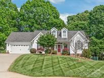 Charming two-story home with a well-manicured lawn, attached garage, and vibrant landscaping, creating a welcoming curb appeal at 1542 Crowders Woods Dr, Gastonia, NC 28052