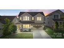 Charming two-story home featuring a welcoming front porch and a well-manicured lawn at 16134 Kelby Cv, Charlotte, NC 28278