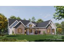 Beautiful single-story home with a brick and siding facade, black roof, and a well-manicured lawn at 1905-A Bechtler Rd, Edgemoor, SC 29712