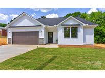 Charming one-story home featuring white siding, a brown garage door, and a well-manicured lawn at 3300 Travis Nw Ln, Concord, NC 28027