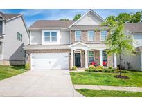 Beautiful two-story home showcasing a well-manicured lawn, brick accents, and a welcoming front porch with rocking chairs at 424 Preston Rd, Mooresville, NC 28117