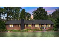 Charming brick home with well-maintained lawn, classic architecture, and mature trees under the colorful hues of dusk at 530 Bonita Dr, Landis, NC 28088