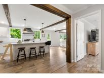 Bright kitchen features a center island with seating and wood beam accents at 5528 Little Mountain Rd, Gastonia, NC 28056