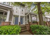 Charming townhome exterior with covered front porch and well-manicured landscaping at 625 N Alexander St, Charlotte, NC 28202