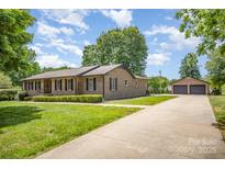 Charming brick ranch home with a well-manicured lawn and a two car detached garage at 174 Wintergreen Cir, Statesville, NC 28677