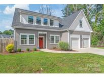 Charming home featuring a red door, two-car garage, and well-maintained landscaping at 1832 Montclair Ave, Gastonia, NC 28054