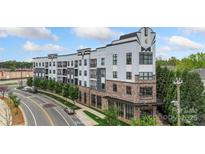 Attractive modern apartment building with distinctive architectural details and street view at 3630 N Davidson St # 3301, Charlotte, NC 28205