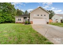 Charming home with a two-car garage, well-maintained lawn, and welcoming curb appeal at 4405 Sugar Cane Ct, Waxhaw, NC 28173
