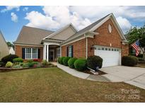 Beautiful single-Gathering home features a well-maintained lawn and attached two car garage at 52538 Winchester St, Fort Mill, SC 29707