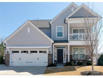Charming two-story home featuring light gray siding, a two-car garage, and inviting front porch at 6176 Russo Ct, Lancaster, SC 29720
