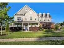 Charming two-story home with manicured lawn, blue door, and lush landscaping at 7216 Old Valley Way, Harrisburg, NC 28075