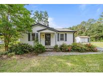 Charming home featuring a cozy entrance, landscaped garden, and well-maintained front yard at 804 Allen Dr, Marshville, NC 28103