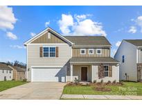 Charming two-story home features a two-car garage, and beautiful landscaping at 1703 Wooten Way, Bessemer City, NC 28016