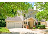 Charming two-story home featuring a welcoming front porch and attached two-car garage at 17219 Grand Central Way, Cornelius, NC 28031