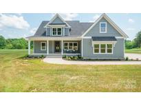Charming two-story home with gray siding, covered front porch, manicured lawn, and walkway at 175 Lone Pine Rd, Statesville, NC 28625