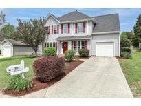 Charming two-story home with red shutters, landscaped yard, and a concrete driveway at 183 Bellelaine Dr, Mooresville, NC 28115