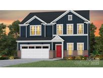 Charming new construction two-story home featuring a brick-accented facade, attached garage and inviting red front door at 2176 Millennium Dr # 093, Lancaster, SC 29720
