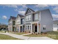 Charming townhomes with varied siding, brick accents, and well-maintained lawns showcase modern living at 5201 Shasta St # 5201, Gastonia, NC 28052