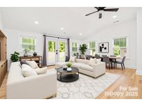 Bright living room with white couches, neutral rug, dining area, and plenty of natural light at 6301 Vernedale Rd, Charlotte, NC 28212